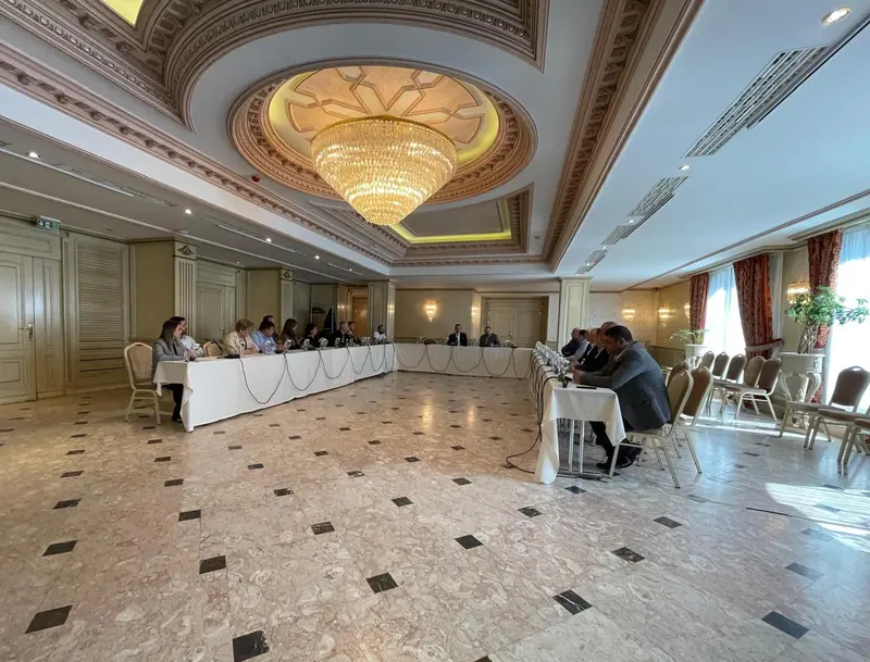 U-shape conference table with microphones in an elegant meeting room