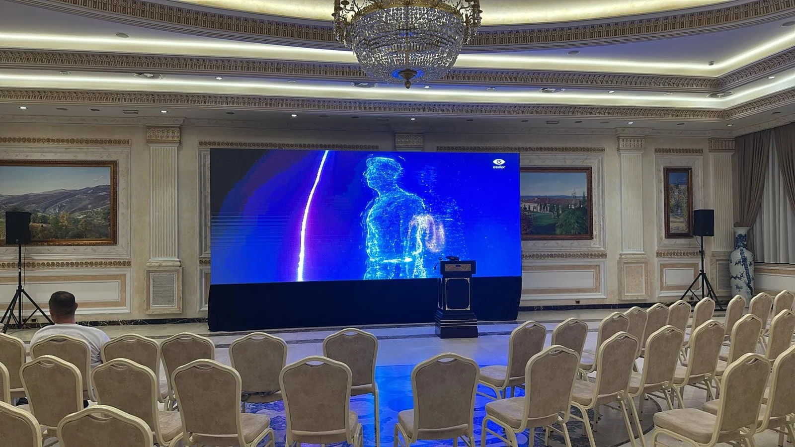 LED video wall and lectern in a conference ballroom